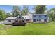 Beautiful backyard featuring a blue home, spacious deck, and manicured lawn at 8100 N Meridian St, Indianapolis, IN 46260