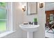 Powder room featuring a pedestal sink, dark faucet and accent lighting at 8100 N Meridian St, Indianapolis, IN 46260