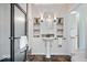 Well-lit bathroom featuring a pedestal sink with shelves, walk-in shower, and neutral color scheme at 8100 N Meridian St, Indianapolis, IN 46260
