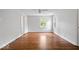 A spacious bedroom with hardwood floors, fresh paint, a ceiling fan, and natural light at 8100 N Meridian St, Indianapolis, IN 46260