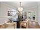 Chic dining room with hardwood floors, stylish lighting, and a view into the modern kitchen at 8100 N Meridian St, Indianapolis, IN 46260