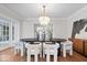 Bright dining room featuring a chandelier and a modern black table surrounded by white chairs at 8100 N Meridian St, Indianapolis, IN 46260