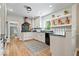 Well lit kitchen showcasing white cabinetry, black appliances and stone countertops at 8100 N Meridian St, Indianapolis, IN 46260