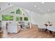 Open-concept living and dining area with vaulted ceilings and large windows showcasing the outdoor view at 8100 N Meridian St, Indianapolis, IN 46260