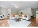 Bright living room featuring a neutral color palette, ceiling fan, and a large sectional sofa at 8100 N Meridian St, Indianapolis, IN 46260