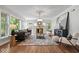 Bright living room features hardwood floors, large windows, and modern furnishings at 8100 N Meridian St, Indianapolis, IN 46260