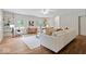 Cozy living room with light walls, hardwood floors, a white sofa and built in bookcases at 8100 N Meridian St, Indianapolis, IN 46260