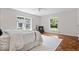 Bright bedroom with hardwood floors, two windows providing great natural light and an accent chair at 8100 N Meridian St, Indianapolis, IN 46260