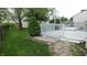 Backyard view featuring a deck, green lawn, and some mature shrubs at 8160 Whitham Dr, Indianapolis, IN 46237
