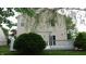 Backyard features a deck with swing, beige siding, and mature trees at 8160 Whitham Dr, Indianapolis, IN 46237