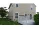View of the backyard with a white deck, beige siding, and green grass at 8160 Whitham Dr, Indianapolis, IN 46237