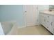 Bathroom featuring a tub, white vanity, and a sink at 8160 Whitham Dr, Indianapolis, IN 46237