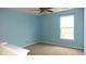 Bedroom with carpet flooring, light blue walls, and a window providing natural light at 8160 Whitham Dr, Indianapolis, IN 46237