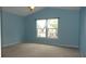 Bedroom with a vaulted ceiling and a large window allowing for natural light at 8160 Whitham Dr, Indianapolis, IN 46237