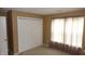 Bedroom featuring carpet, a closet with white doors, and a window that allows natural light at 8160 Whitham Dr, Indianapolis, IN 46237