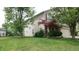 Well maintained 2-story home with a green lawn and mature trees surrounding the property at 8160 Whitham Dr, Indianapolis, IN 46237