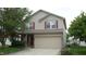 Charming two-story home featuring a two-car garage, neutral siding, and complementary red shutters at 8160 Whitham Dr, Indianapolis, IN 46237