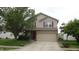 Charming two-story home featuring a two-car garage, neutral siding, and complementary red shutters at 8160 Whitham Dr, Indianapolis, IN 46237