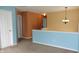 Bright hallway with neutral carpet, blue accents and decorative light fixture at 8160 Whitham Dr, Indianapolis, IN 46237