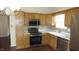 Traditional kitchen featuring stainless steel appliances, and light wood cabinetry with a tile backsplash at 8160 Whitham Dr, Indianapolis, IN 46237