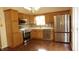 Eat-in kitchen featuring stainless steel appliances, natural wood cabinets and hardwood floors at 8160 Whitham Dr, Indianapolis, IN 46237
