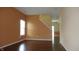 Spacious living room with hardwood floors, large windows, and light-filled open floor plan at 8160 Whitham Dr, Indianapolis, IN 46237