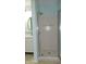 Shower with a glass door, round mirror, and modern fixtures at 8160 Whitham Dr, Indianapolis, IN 46237