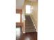 A carpeted staircase connects the lower and upper levels of the home with natural light at 8160 Whitham Dr, Indianapolis, IN 46237