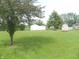 Expansive, well-maintained backyard with storage sheds, mature trees and plenty of green space for outdoor activities at 833 N 700 W, Greenfield, IN 46140