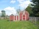 A red barn with white trim and a charming country aesthetic enhances the property's appeal at 833 N 700 W, Greenfield, IN 46140