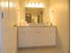 Bathroom boasts modern vanity with sleek fixtures, storage, and tiled floors at 833 N 700 W, Greenfield, IN 46140