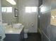 Modern bathroom featuring a vessel sink, tiled shower, and natural light from two windows at 833 N 700 W, Greenfield, IN 46140