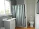 Functional bathroom featuring a sink with cabinet, toilet, and shower with curtain rod and curtain at 833 N 700 W, Greenfield, IN 46140