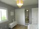 Cozy bedroom with chandelier lighting, ample closet space, and a large window for natural light at 833 N 700 W, Greenfield, IN 46140