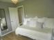 Bedroom featuring comfortable daybed, a chic mirror, and door for seamless indoor-outdoor flow at 833 N 700 W, Greenfield, IN 46140