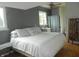 Cozy bedroom featuring a large bed, ceiling fan, and windows that let in natural light at 833 N 700 W, Greenfield, IN 46140