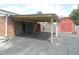 A carport with a brick facade and wood columns provides covered parking and storage at 833 N 700 W, Greenfield, IN 46140