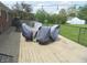 Wooden deck with an outdoor dining area covered for protection at 833 N 700 W, Greenfield, IN 46140