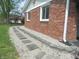 Charming brick home with a stone walkway and landscaped garden area at 833 N 700 W, Greenfield, IN 46140