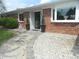 Charming brick home with manicured landscaping and stone walkway leading to the front entrance at 833 N 700 W, Greenfield, IN 46140