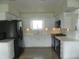 Bright kitchen featuring white cabinetry, stainless appliances, and hardwood floors at 833 N 700 W, Greenfield, IN 46140