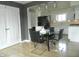Eat-in kitchen featuring modern black appliances, white cabinetry and a glass dining table with black chairs at 833 N 700 W, Greenfield, IN 46140