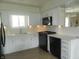 Well-lit kitchen with white cabinets, modern appliances, and sleek countertops at 833 N 700 W, Greenfield, IN 46140