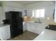Modern kitchen with white cabinets, stainless steel appliances, and ample counter space at 833 N 700 W, Greenfield, IN 46140