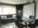 Cozy living area with a bay window, comfortable seating, and modern decor at 833 N 700 W, Greenfield, IN 46140