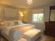 Comfortable main bedroom features plush bedding, a window for natural light, and lovely accent furnishings at 833 N 700 W, Greenfield, IN 46140
