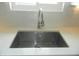 Close-up of a sleek, stainless steel sink and chrome faucet set in bright countertop at 833 N 700 W, Greenfield, IN 46140