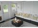 Cozy sunroom with plush seating and ample natural light from surrounding windows and door at 833 N 700 W, Greenfield, IN 46140
