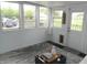 Bright sunroom featuring multiple windows, a door to the outside, and a patterned rug at 833 N 700 W, Greenfield, IN 46140