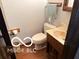 Cozy half bathroom features a wood vanity with marble countertop at 8835 Winding Ridge Rd, Indianapolis, IN 46217